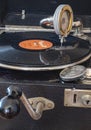 Components of an old gramophone from the company Odeon from Germany in the 1920s with a shellac disc, pickup, a box for the plate Royalty Free Stock Photo