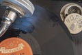 Historic shellac disc by Polydor with a part of the pickup and a box for the plate needles of an old gramophone from the company O Royalty Free Stock Photo