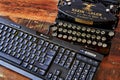 Historic typewriter and modern keyboard that show the progress of the last 100 years