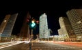 Night photo of a busy intersection in Potsdamer Platz in Berlin, Germany with a traffic light. Bustling cityscape by a crossroad Royalty Free Stock Photo