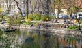 Berlin, Germany - April 20, 2021: People relaxing on a spring day by the Spree in Berlin-Kreuzberg, Germany.