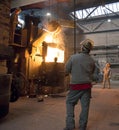 Berlin, Germany - April 18, 2013: Production of metal components in a foundry - group of workers