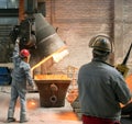 Berlin, Germany - April 18, 2013: Production of metal components in a foundry - group of workers