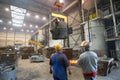 Berlin, Germany - April 18, 2013: Production of metal components in a foundry - group of workers