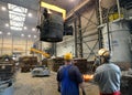 Berlin, Germany - April 18, 2013: Production of metal components in a foundry - group of workers