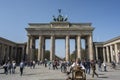 BERLIN, GERMANY, APRIL 17, 2018: A Street Organ player in front of The Brandenburger Tor at Pariser Platz with many unidentified t