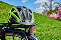 Yellow bike helmet lying on the luggage rack of a bicycle Royalty Free Stock Photo