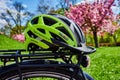 Yellow bike helmet lying on the luggage rack of a bicycle Royalty Free Stock Photo