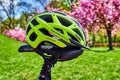 Yellow bike helmet lying on the saddle of a bicycle Royalty Free Stock Photo