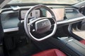Berlin, Germany - August 20, 2022: Car Detail XPeng P7 EV Motors electric car badges logo emblem on steering wheel with