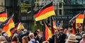 Demonstrators wave the black-red-gold flag of Germany during a demonstration