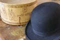 A historic hatbox from Berlin in the 19th century with a bowler on an old wooden table