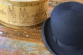 A historic hatbox from Berlin in the 19th century with a bowler on an old wooden table