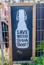 BERLIN, GERMANY - AUGUST 6, 2017: Poster Save water drink beer in Mauerpar Royalty Free Stock Photo