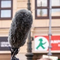 Professional microphone with windscreen for a television crew`s outside interview
