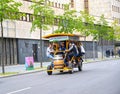 BERLIN, GERMANY. Young people ride a tourist bike car down the street