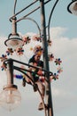 Berlin, Germany - 7/27/2019: Christopher street day in Berlin, street art performer on a light pole. Berlin pride.