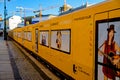 Berlin, Germany - December 02, 2016: projekt u5 berlin. Long yellow poster showing underground train with people and bears