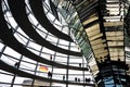 View through the interior of the glass dome at the top of the Reichstag, a historic building which houses the Bundestag, the lower Royalty Free Stock Photo