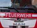 Berlin, Germany - February 09, 2020: The white letters Feuerwehr, the german firefighter logo, on red MAN truck