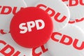 German Election Politics Badges Concept: Pile of CDU Buttons With Red SPD Button, 3d illustration