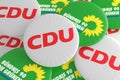 German Politics Concept: Pile of Buttons With The Logo of The Political Parties CDU And The Greens, 3d illustration