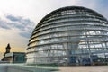 Reichstag dome exterior in summer. Yellow sunlight reflection on glass window