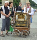 Berlin, Germany - July 2015 - Barrel organ player with elderly tourist couple Royalty Free Stock Photo