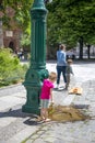 Children near the fountain with drinking water in the center of Berlin in hot summer Royalty Free Stock Photo