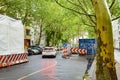 Cityscape: A car is currently passing a construction site in downtown Berlin on a rainy day