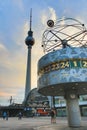 World Clock Weltzeituhr at sunset in Alexanderplatz. Berlin TV tower Fernsehturm and train station on the background. Royalty Free Stock Photo