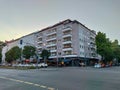 Municipal residential building with balconies and pink facade on the corner of the crossroad Royalty Free Stock Photo