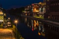 Night shot of a harbor on the Teltow Canal in Berlin-Tempelhof with old warehouses. There are also restaurants with colorful light