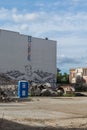 BERLIN, GERMANY - July 28, 2018: Perspective of an angel painting in white wall behind a lot of construction debris, a