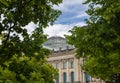 Berlin, Germany - June 29, 2022: The dome of the Reichstag, seat of the German Bundestag, through the trees of the Tiergarten. The Royalty Free Stock Photo