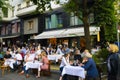 Fully occupied tables and chairs at a street festival. Guests eating and drinking in a restaurant in the center of Berlin