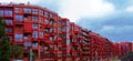 Huge red long skyscraper, GSW Lokschuppen, in Berlin against cloudy sky, Panorama