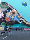 Kids playing outdoor on soccer playground on street with graffiti mural in background in Berlin, Kreuzberg