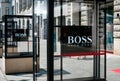 The logo / brand name of HUGO BOSS on shop facade exterior in Be