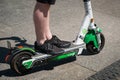 Man riding an electric scooter , escooter or e-scooter of the ride sharing company LIME