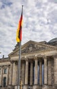 Berlin, Germany - June 29, 2022: The Reichstag Building, seat of the german parliament, the Bundestag. The german flag in front on Royalty Free Stock Photo