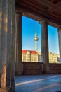 View through historic arcades on Museum Island in Berlin, Germany, to the TV tower at Alexanderplatz