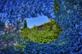 View through a hole in the broken glass of a window onto the platform of a historic train station in Berlin, Germany