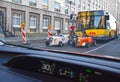 View through a windshield at two tiny hot rods and a typical berlin bus directly behind them in the inner city of berlin