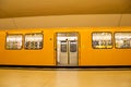 Yellow metro subway with open door in Berlin, Germany