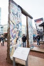Tourists looking at a piece of the Berlin Wall at the entrance of the BlackBox Cold War Museum Royalty Free Stock Photo