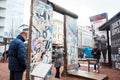 Tourists looking at a piece of the Berlin Wall at the entrance of the BlackBox Cold War Museum Royalty Free Stock Photo