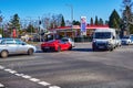 View to the price board of an Esso Group gas station with extremely high prices and a sports car on the crossing Royalty Free Stock Photo