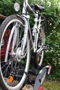 Detail view of a bicycle on a bike carrier mounted on the back of a car Royalty Free Stock Photo