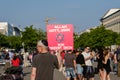 Man holding sign for religous tolerance, praising God, Allah and